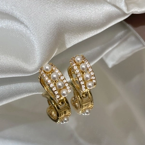 Elegant gold pearl hoop earrings featuring micro-pave zircons for a luxury look