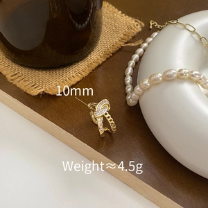 Detailed close-up of 10mm gold-plated knot chain earring with cubic zirconia micro-pave