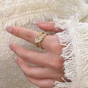 Gold plated knot ring with cubic zirconia baguette stones and cuban chain design