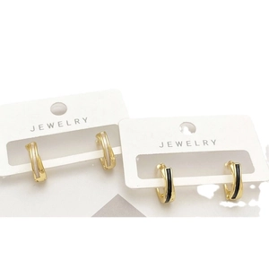 Crossed shell inlay hoop earrings in gold plated copper with black and white shell accents