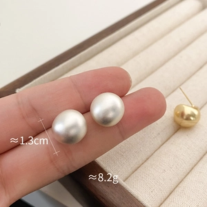 Detail of matte silver dome earrings showing 1.3cm diameter and 8.2g weight size info