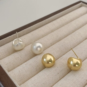 Minimalist drop earrings in matte pearl white and polished gold finishes