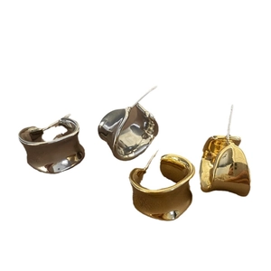 Minimalist C-shape chunky hoop earrings with wavy metal texture in gold and silver