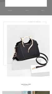 Close-up of black handbag featuring unique golden cat-ear metal handles and contrast stitching