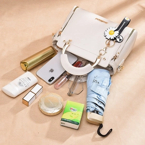 Chic beige handbag with gold handles and large capacity for daily essentials