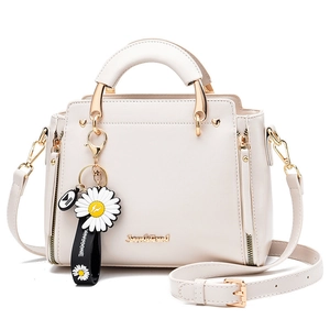 Fashionable cream white women's handbag with daisy charm and adjustable shoulder strap