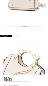 Detail view of cat-ear metal handles and bottom studs on off-white women handbag