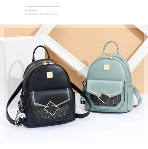 Detail view of mini backpacks in black and green with sequins and bear charms