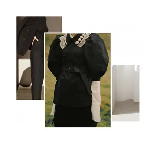 Vintage black dress detail featuring elegant puff sleeves and white lace collar with pearls