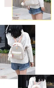 Detailed size comparison showing large and small beige printed backpacks with pink straps
