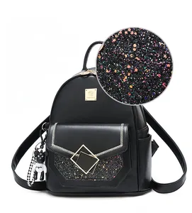 Detail of black mini backpack with starry sequins, metal clasp and cute bear charm
