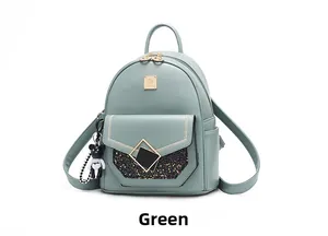 Detail of mint green PU leather backpack featuring black glitter panel and gold buckle
