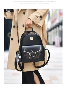 Detailed view of black synthetic leather backpack with metallic clasp and sequined panel