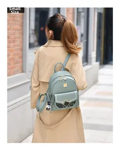 Detail of mint green leather mini backpack with sequined flap and cute bear charm