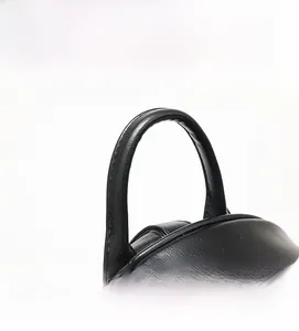 Detail view of the durable PU leather top handle and neat stitching of this black backpack