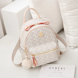 Women's chic monogram backpack in cream and red with plush pendant and bow detail