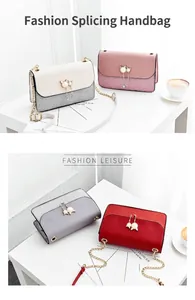Detail of a fashion patchwork handbag with cat-shaped pearl buckle and chain strap
