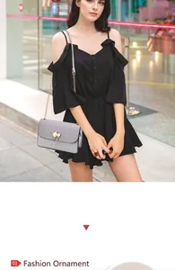 Detailed view of grey crossbody bag with pearl cat ear ornament and golden chain strap