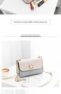 Detail of glitter crossbody bag with cat-shaped pearl charm and golden chain strap
