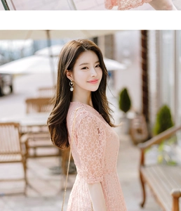 Close-up of elegant pink floral lace texture on a stylish women's fitted dress