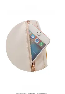 Detail of beige nylon backpack featuring back anti-theft zipper pocket for smartphone