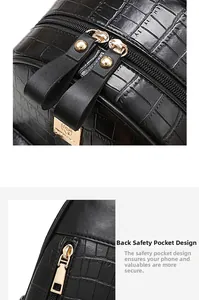 Detail view of crocodile texture leather backpack with golden dual metal zippers and anti-theft pocket