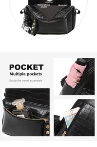 Detail view of large capacity black faux leather bag with organizer pockets and a bear charm