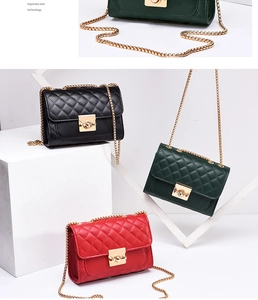 Detail view of quilted crossbody bags in black, green, and red with gold chain straps