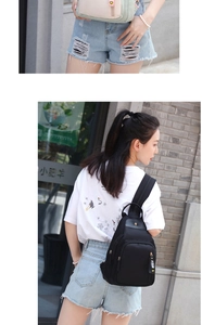 Detail view of water-resistant nylon backpack with multi-layer zippers and side straps