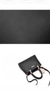 Detail of black pebbled PU leather handbag with gold hardware and plush charm
