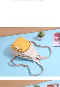 Detail of high-density nylon backpack showing contrasting yellow pocket and FIDM ribbon