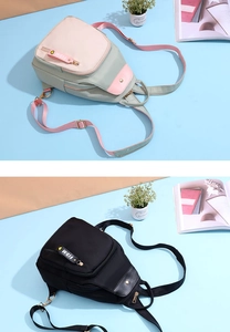 Close-up of stylish nylon mini backpacks in pink-green and black with FIDM straps