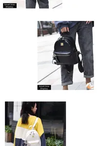 Detailed view of crocodile pattern leather backpack with gold metal logo and zip pockets