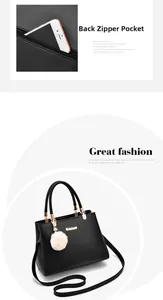 Detail view of the back zipper pocket on a black leather handbag with golden hardware