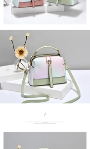 Detail of gradient crossbody bag with pink, purple, and blue hues on white display stand