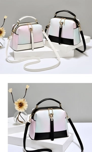 Detail of gradient macaron handbag with dual zippers and adjustable shoulder strap
