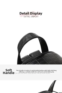 Detail of crocodile embossed leather texture and sturdy reinforced stitching on handle