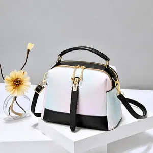 Detail of gradient crossbody bag featuring pebbled leather texture and metal zipper