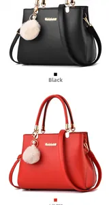 Close-up of black and red leather handbags featuring metal logo and white fluffy pompom charm