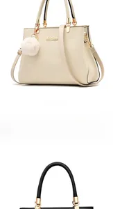 Detail of leather tote bags in white and black with metal logo and fluffy ball charm