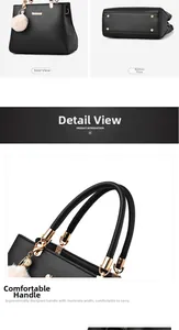 Detail view of black PU leather handbag featuring metal handles and protective base studs