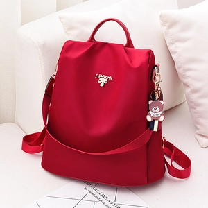Mochila roja impermeable para mujer en tela Oxford con un lindo colgante de oso