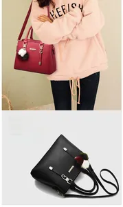 Detailed view of structured tote bag with pebble texture and colorful plush charm