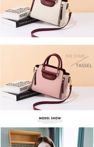 Detail view of stylish tote bags in pink and beige color-blocking with top handles