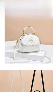 Detail of white quilted leather semicircular bag with gold M logo and dual zippers