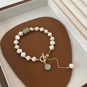 Baroque freshwater pearl bracelet with green accents and gold OT toggle clasp closure