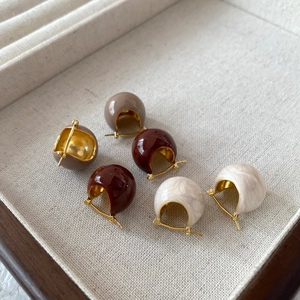 Three pairs of vintage C-shaped enamel hoop earrings in burgundy, taupe and marble white