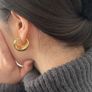 French vintage thick gold hoop earrings in a minimalist wide smooth curved design