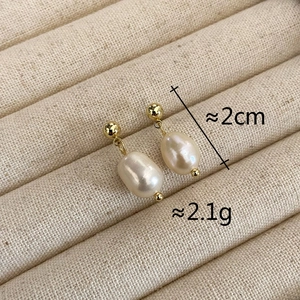 Detail showing 2cm gold-plated freshwater pearl earrings with 2.1g weight display
