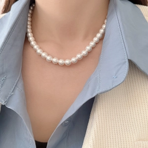 Close-up of model wearing 8-9mm round cream white pearl necklace with glossy finish